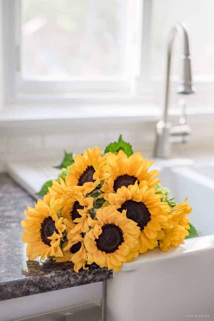 Bring flowers into your white kitchen to add character.