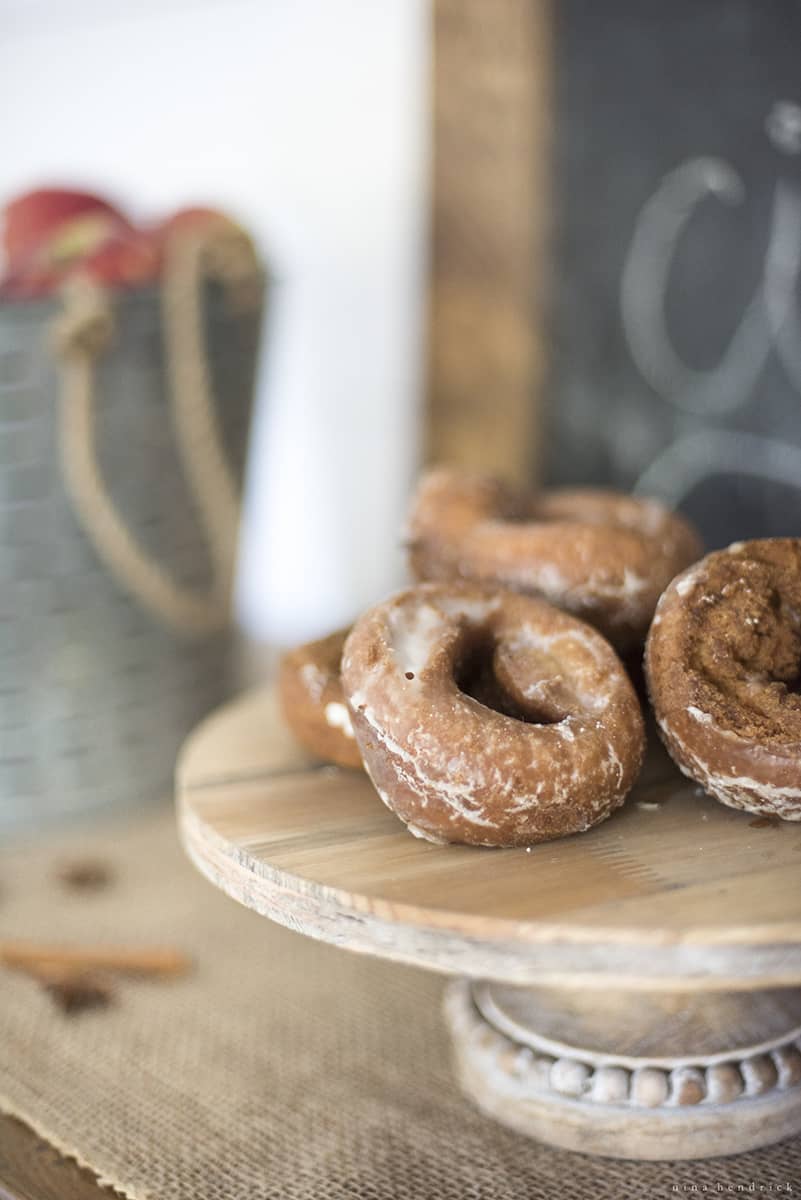Donuts on a wooden plate.