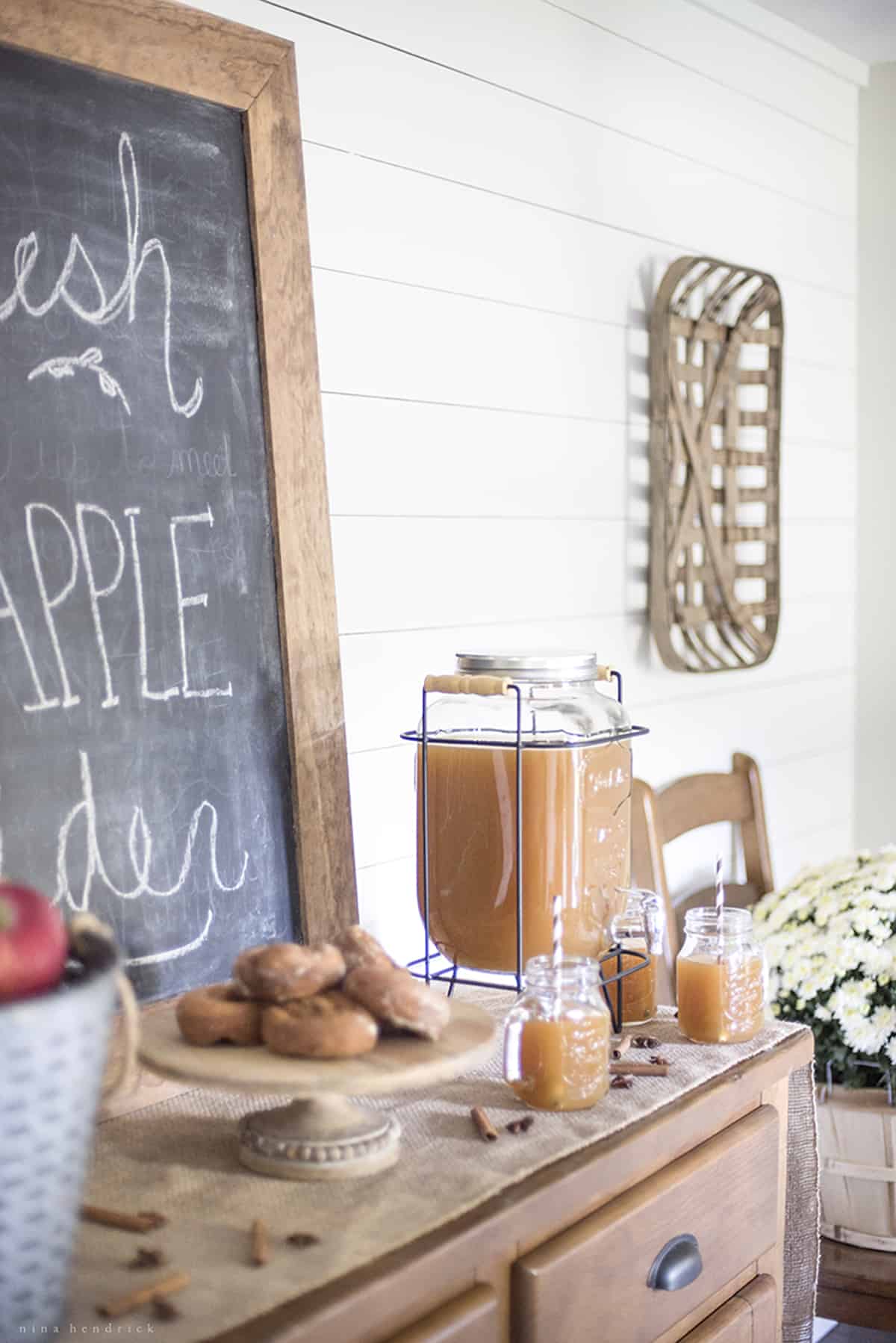 A table with apples on it, transformed into an Apple Cider Bar.