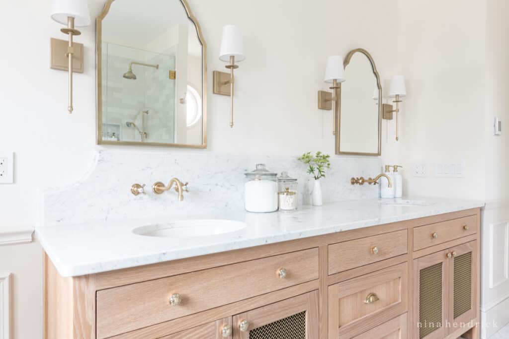 timeless bathroom design ideas: Natural materials such as a warm wood vanity with marble countertop