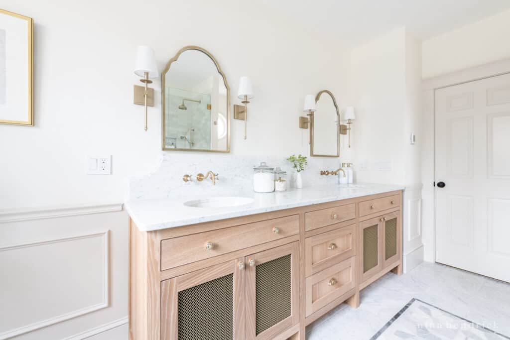 Custom white oak bathroom vanity with brass mesh door panels