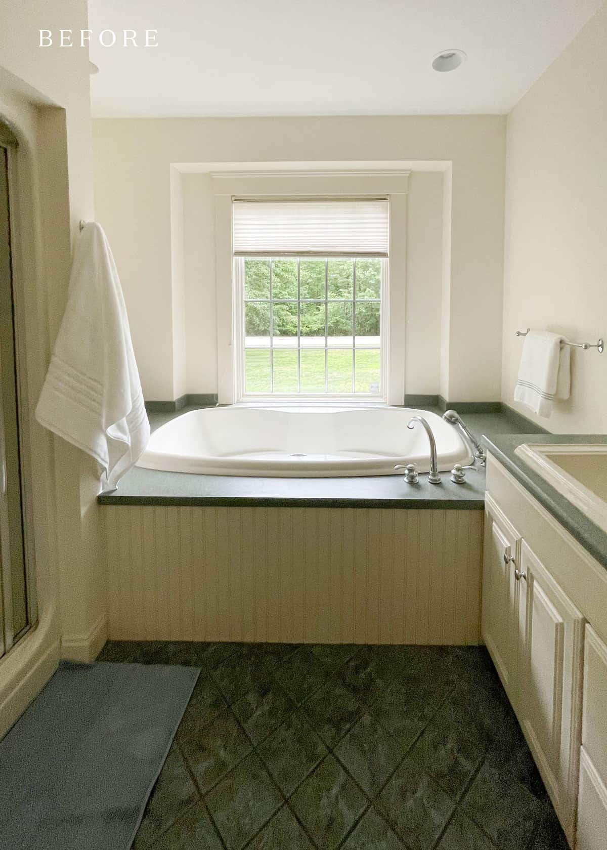 Before bathroom remodel with large tub and green tile