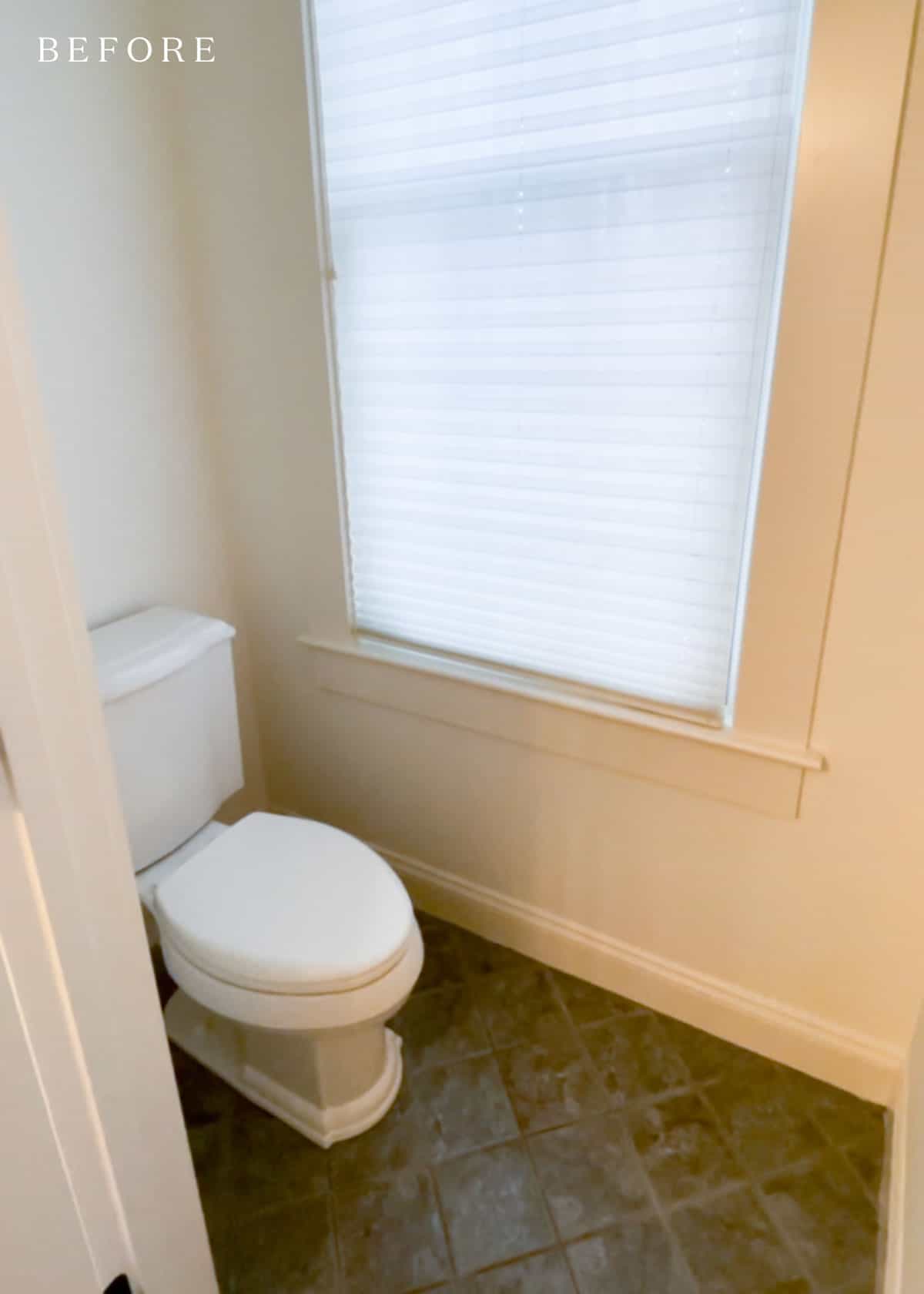 Water closet with large window and green tile