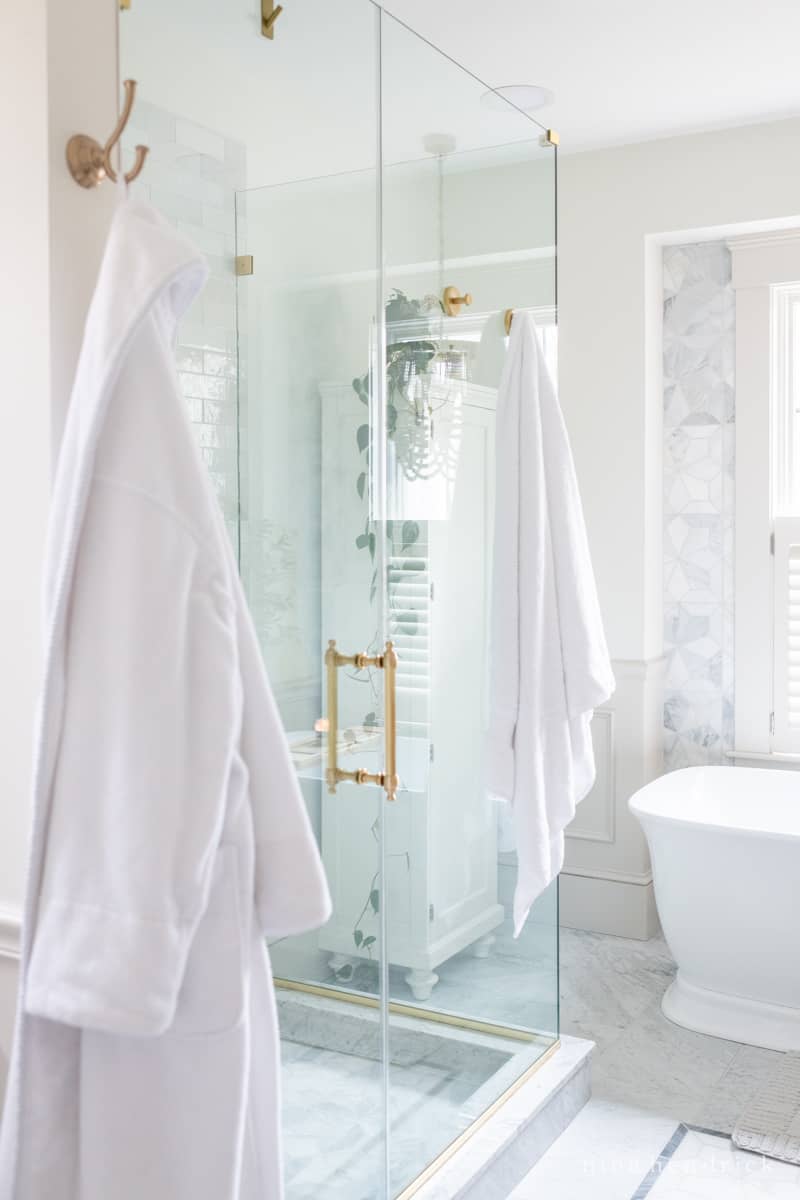 Towel and robe hanging from bathroom hooks