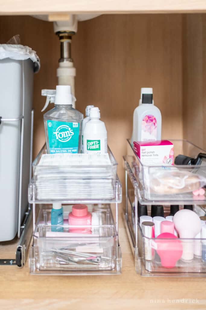 Clear acrylic tiered bins on drawer slides for bathroom storage