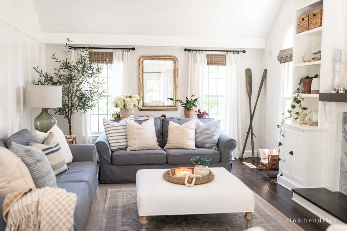 Coastal living room with neutral paint colors Benjamin Moore Balboa Mist walls and Simply White trim.