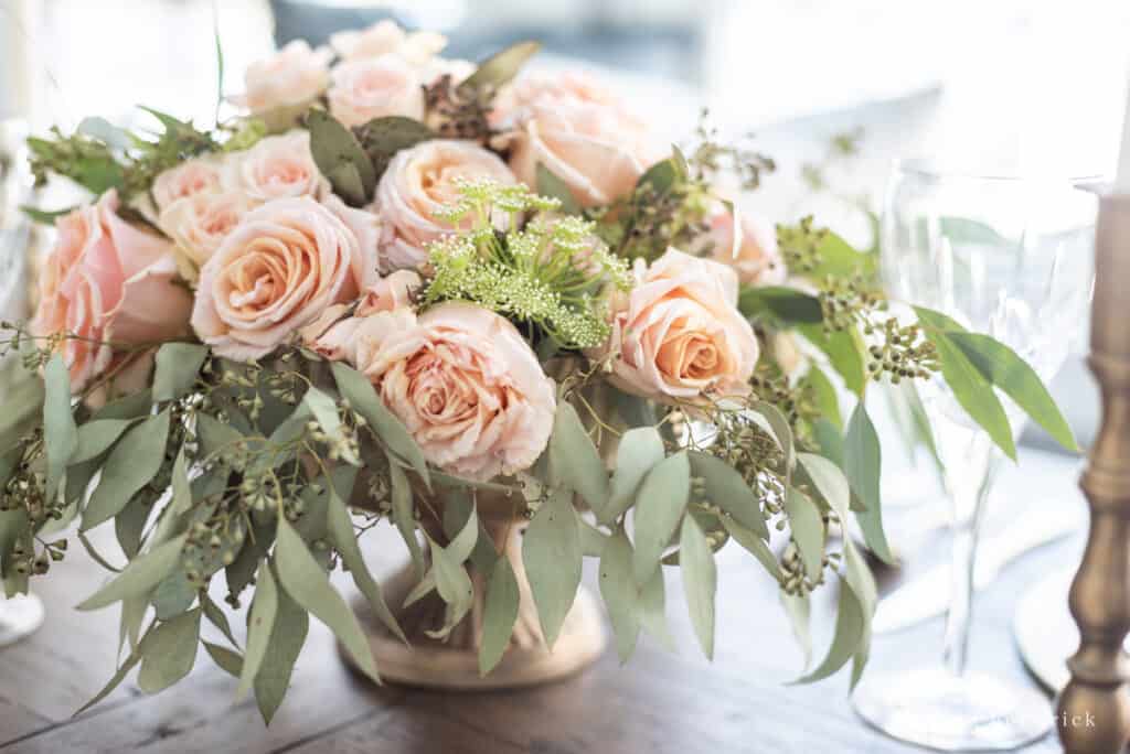 Floral arrangement with blush roses, seeded eucalyptus, and Queen Anne's Lace