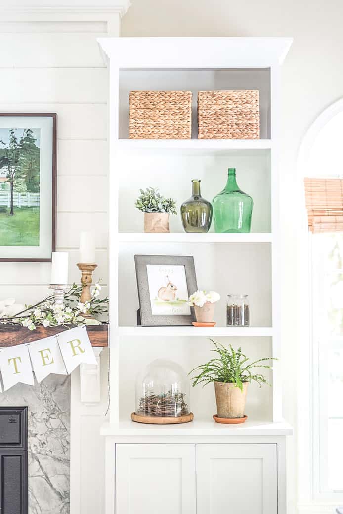 Bookshelves decorated for spring and Easter with bunny prints and florals