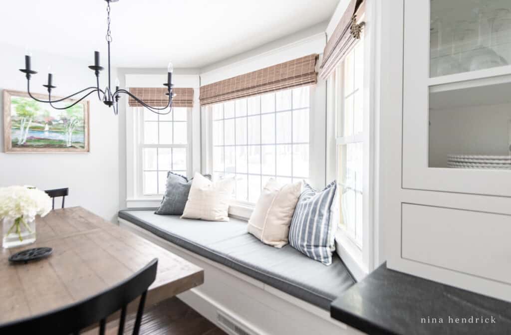 bay window bench with a cushion and pillows