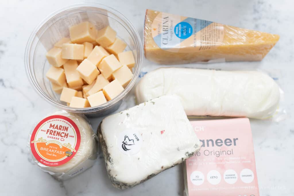 Varieties of cheese on a marble countertop