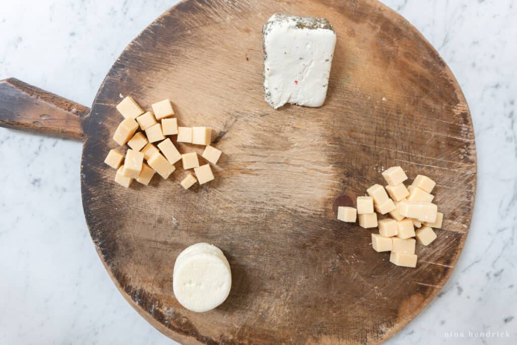 Different types of cheese on a wooden board