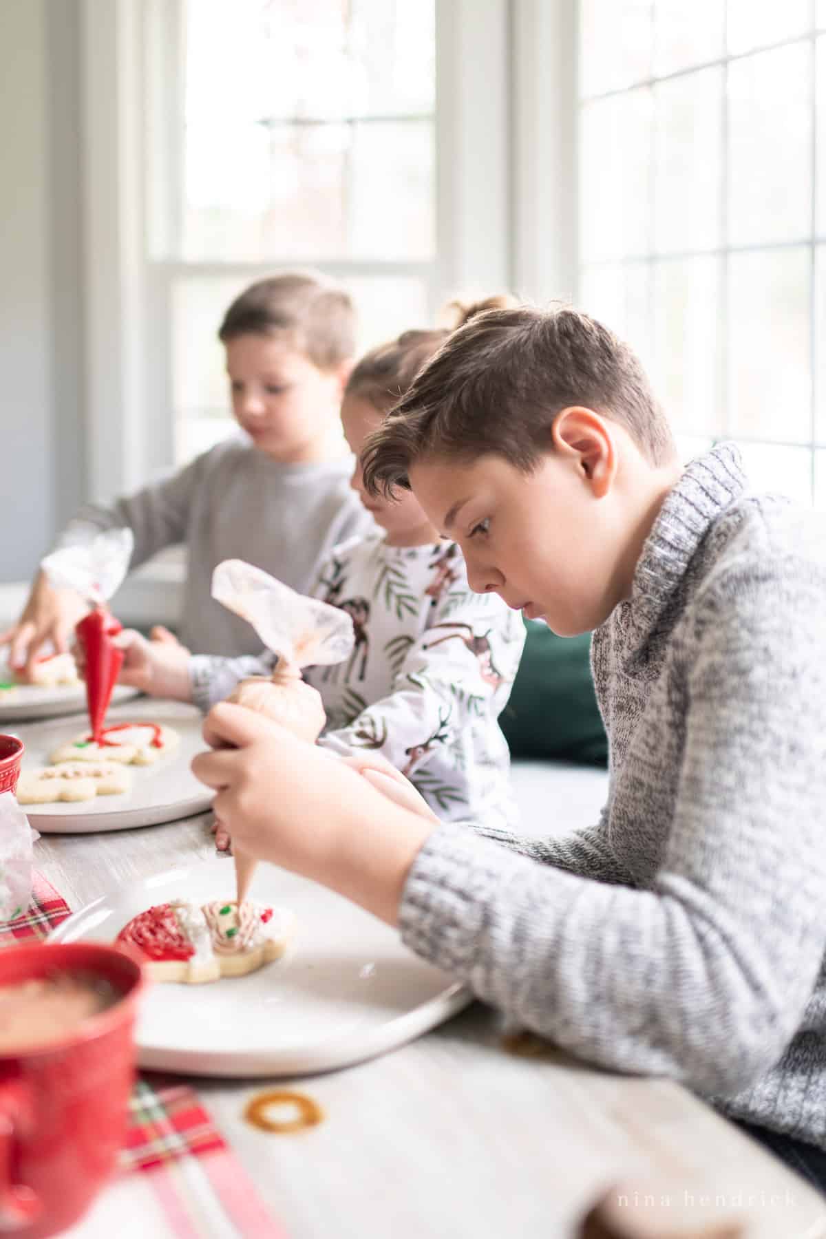 Children decorating cookies at a Christmas party