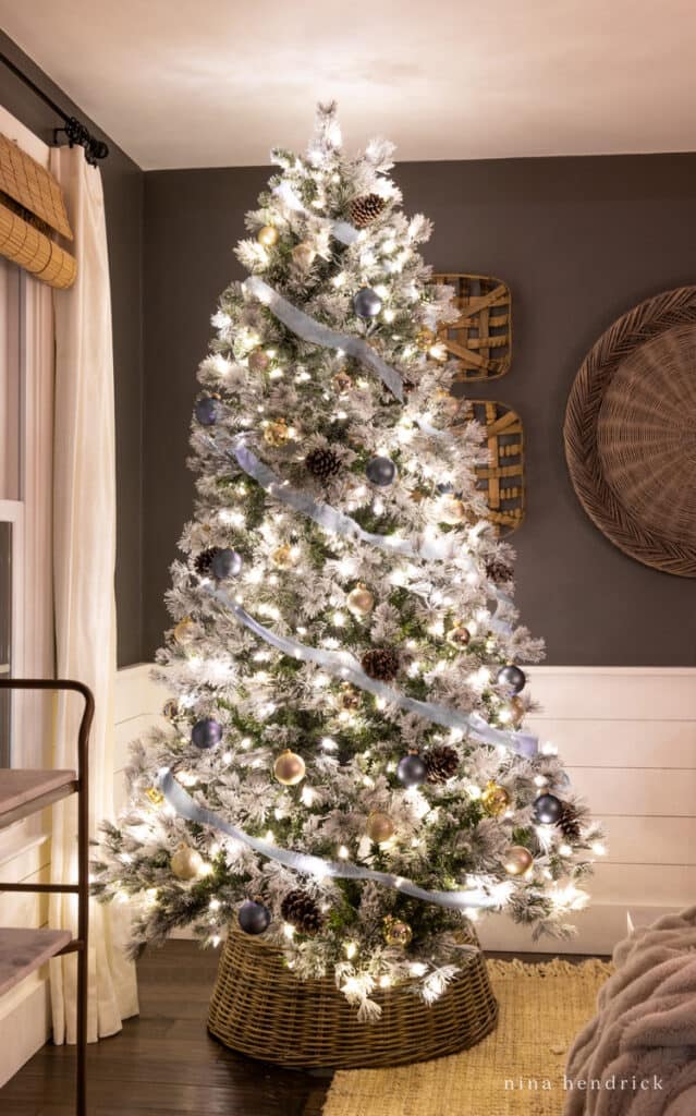Christmas tree at night with blue ribbon and ornaments