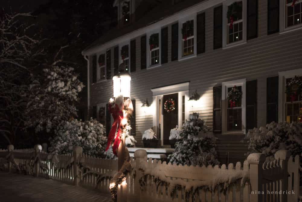 Holiday house outdoor decor and lantern post with garland and ribbon