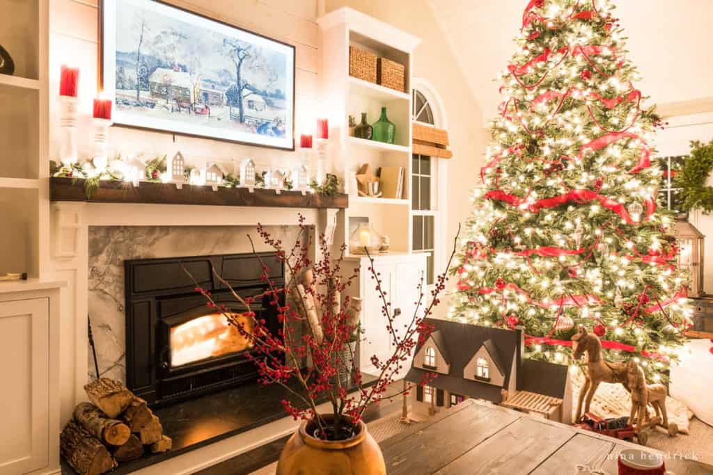 Christmas lights at night in the family room with a Christmas tree and fireplace