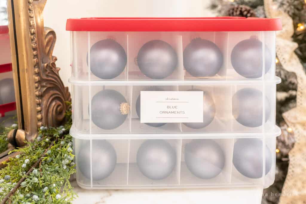 Blue Christmas ornaments in a plastic storage container