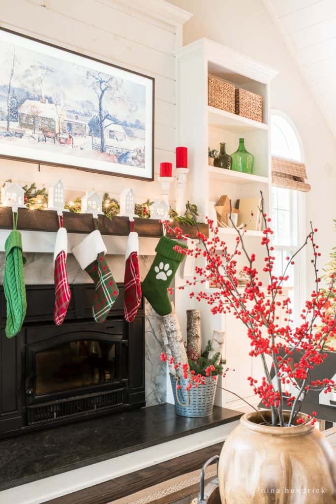 Mantel hung with stockings in a Traditional Red and Green Family Room