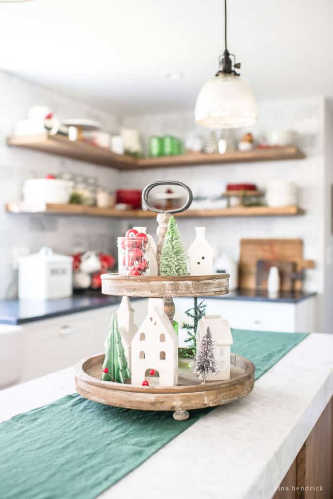 Tiered Tray featuring a white porcelain village in a Classic Christmas Kitchen