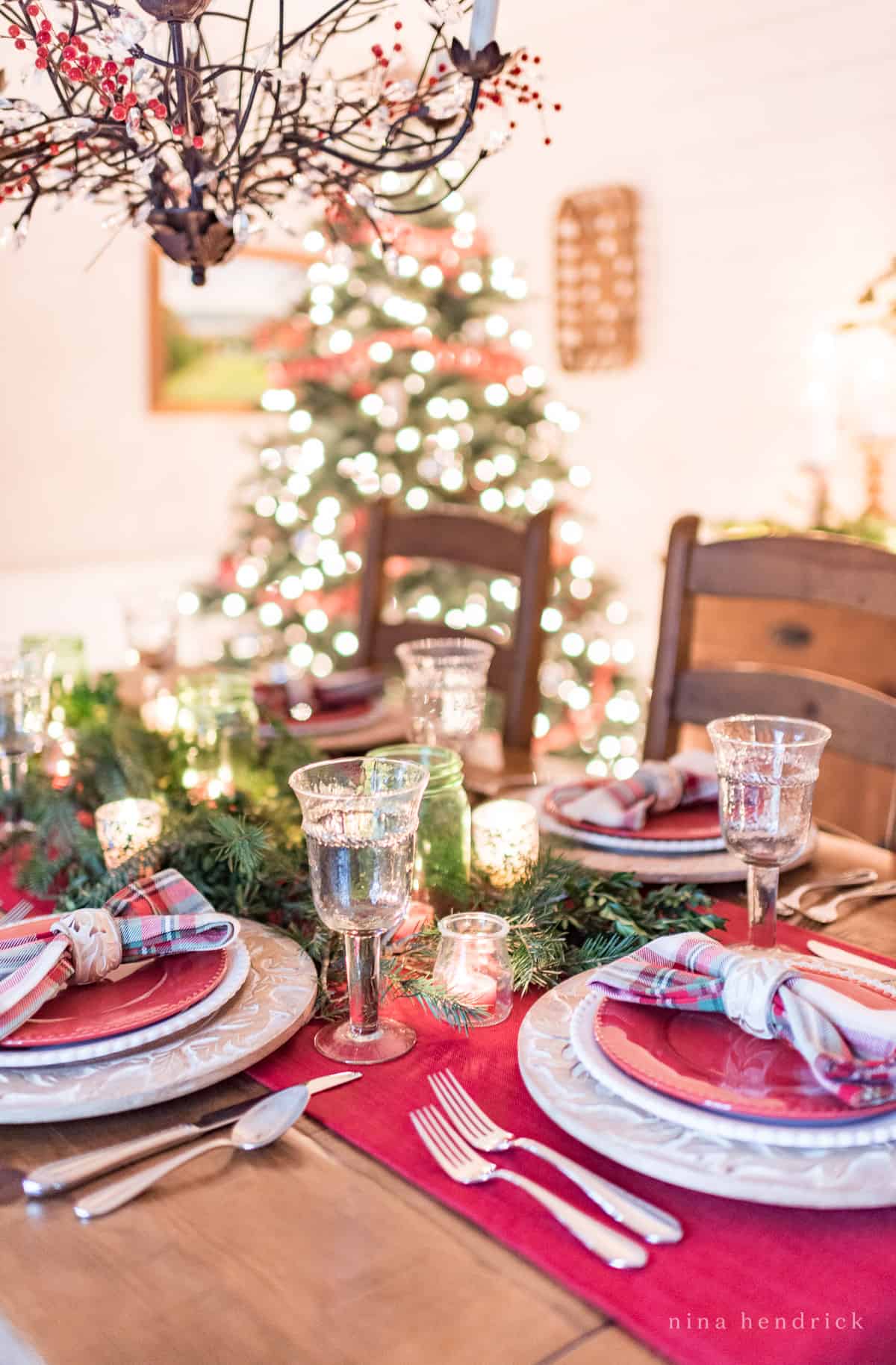 Gather inspiration for your holiday entertaining with this Classic Christmas Tablescape featuring traditional reds and greens. red and green place settings