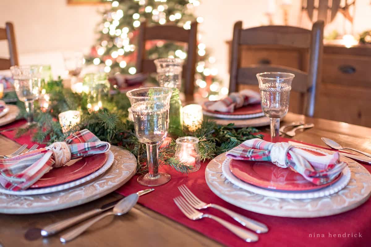 Gather inspiration for your holiday entertaining with this Classic Christmas Tablescape featuring traditional reds and greens. Holiday table decoration ideas for a classic look