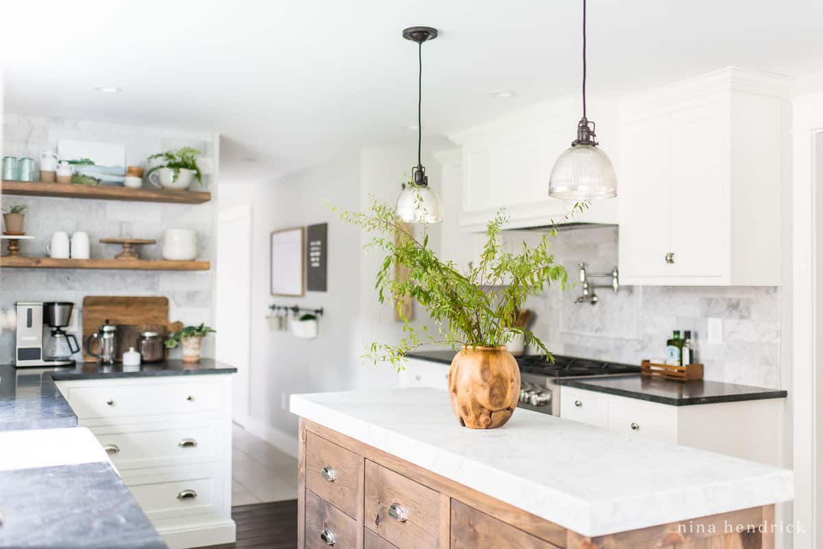 Classic kitchen makeover with white cabinets and mercury glass pendants
