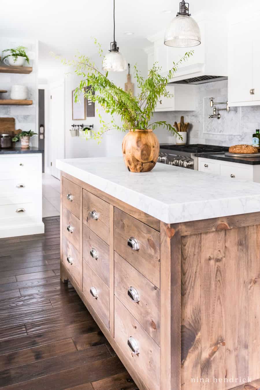 custom built white pine stained wood kitchen island with a marble top
