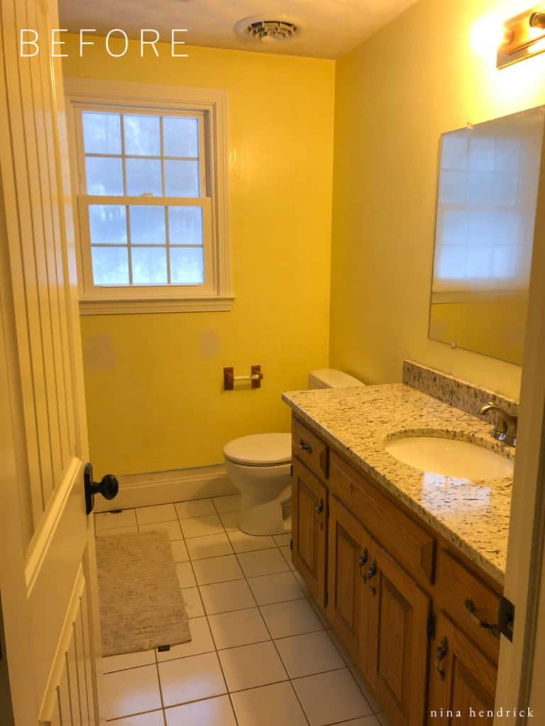 Before photo of a dated yellow builder-grade bathroom.