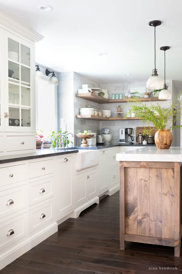 Semi-custom white cabinetry with a contrasting wood island