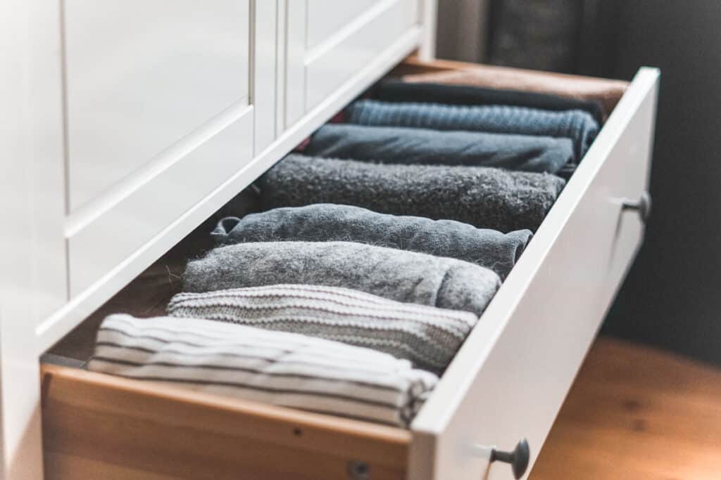 Sweaters folded vertically, file style in a drawer