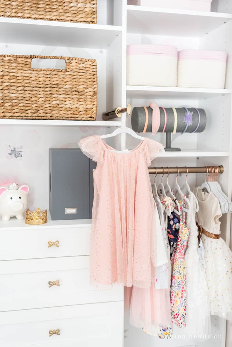 Closet organization idea of using a valet rod to plan outfits and steam clothes easily