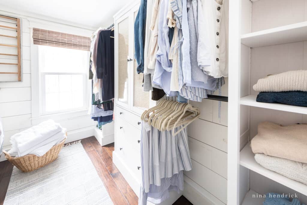 Walk-in closet with a laundry basket and a bright window
