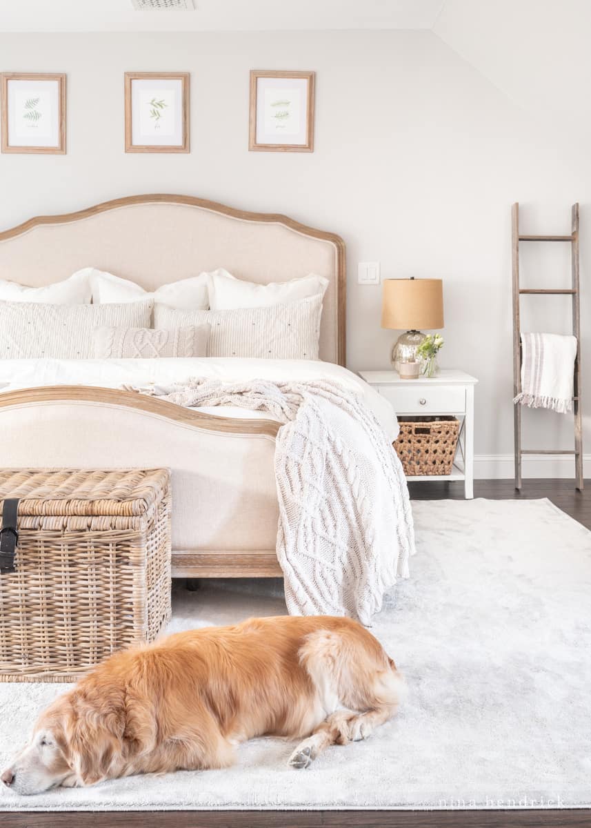 Neutral bedroom with cozy knits and a golden retriever