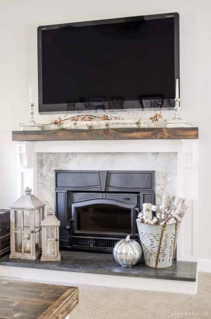 wood and stone covering a dated brick fireplace for a modern update