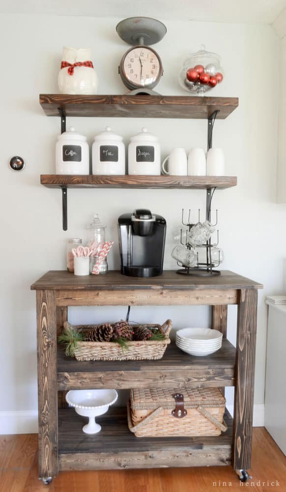 Hot chocolate wooden bar cart with wooden shelves and white jars above the coffee maker.