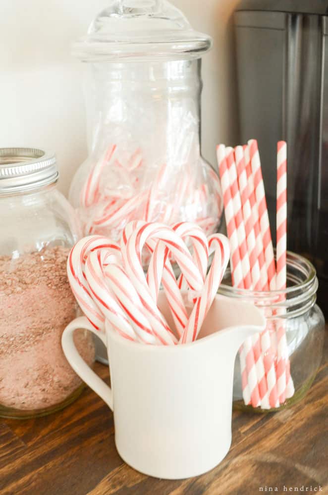 Candy canes and paper straws with hot chocolate mix.