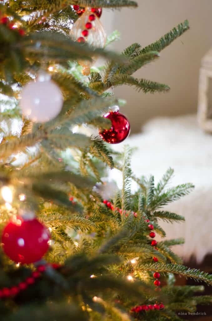 Red and white ornaments on a natural Christmas tree