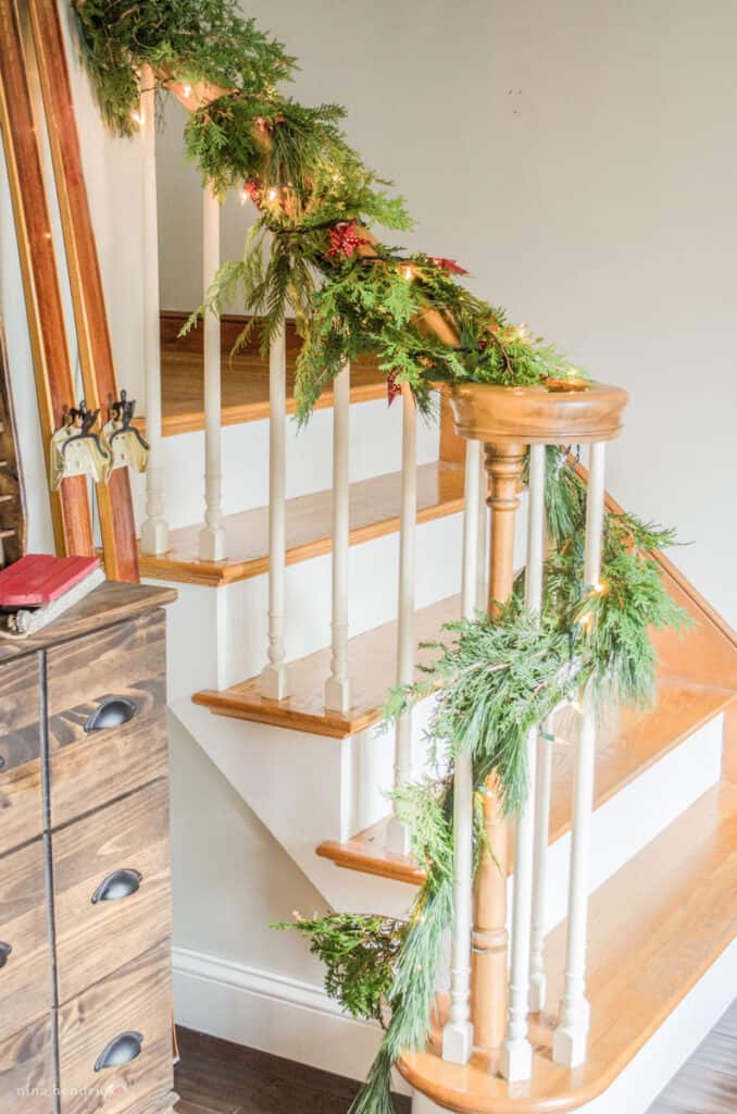 Stair banner with fresh green garland for a cozy Christmas decorating idea