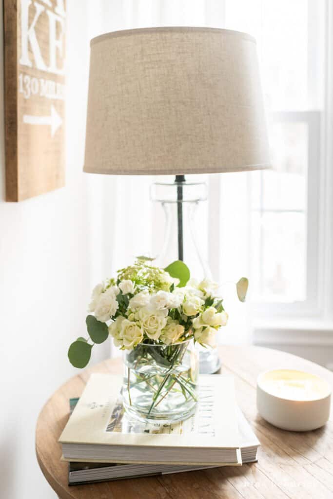 Flowers on a table with a candle burning