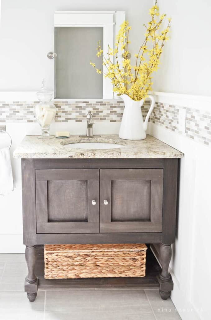 DIY Bathroom Vanity with turned legs and dark finish inspired by the Pottery Barn Newport Sink Console