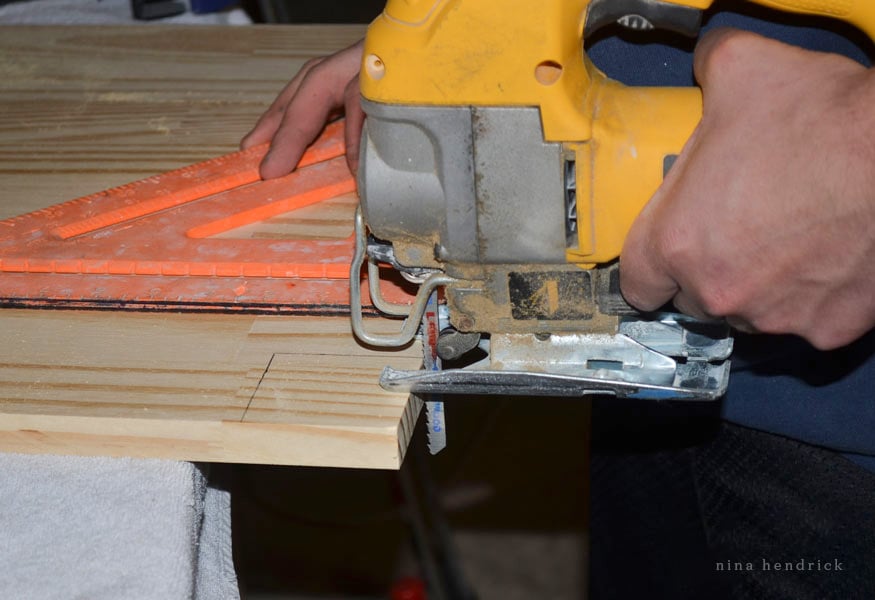 Cutting a bottom shelf panel with a jigsaw