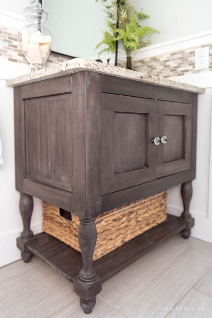 DIY Bathroom Vanity sink console with dark weathered finish and wicker basket