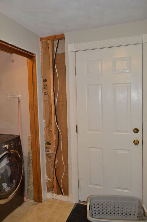 Before DIY mudroom makeover — transforming a laundry closet near garage entry.
