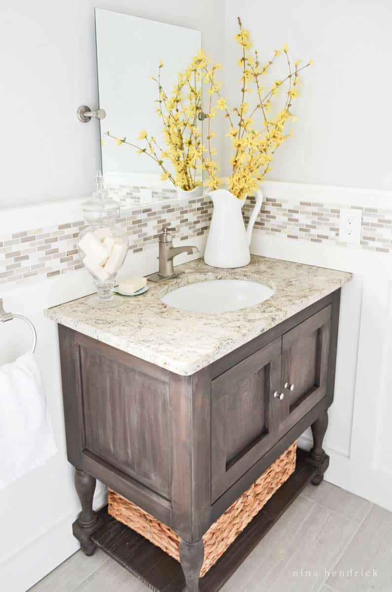 Yellow branches on top of the bathroom vanity in a powder room makeover
