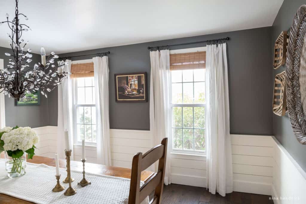 Dining room with shiplap half-wall treatment and dark painted walls