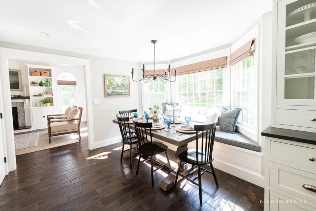 Breakfast nook and living room entrance with dark hardwood flooring. 