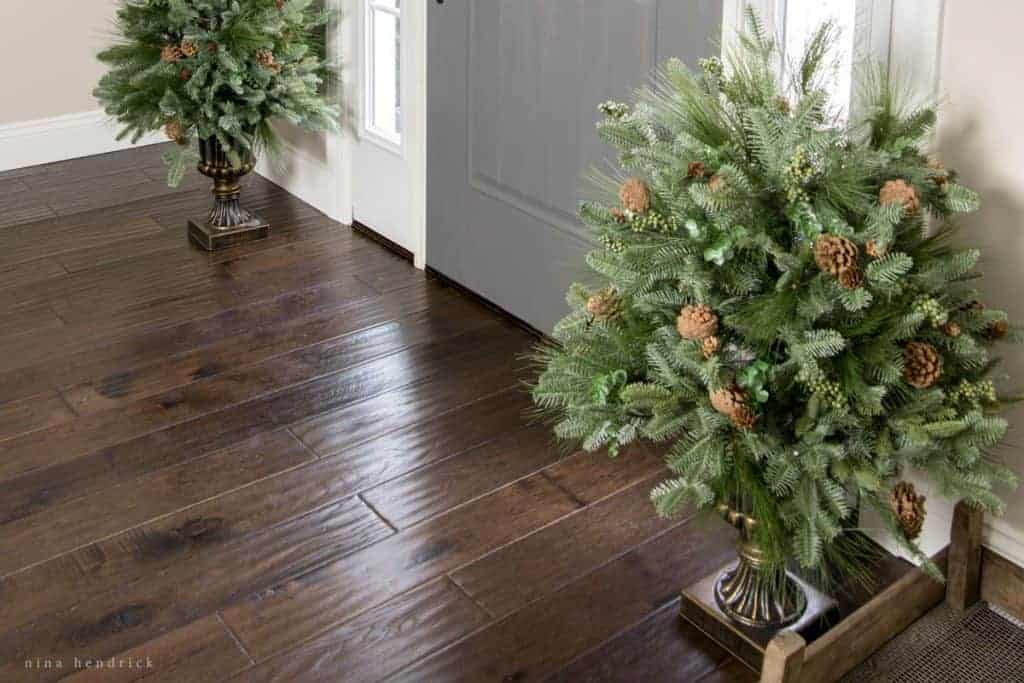 Close-up of entryway with dark, hand scraped hardwood flooring.