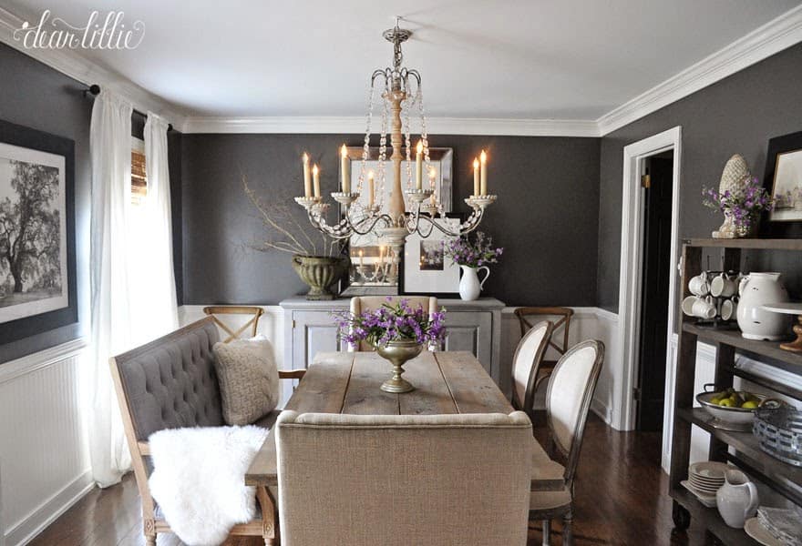 See the inspiration behind a Collected and Contrasting Dining Room Design. This room features a bold wall color, antique finishes, and a ton of texture. 