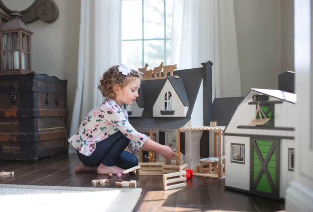Little Girl Playing with dollhouse