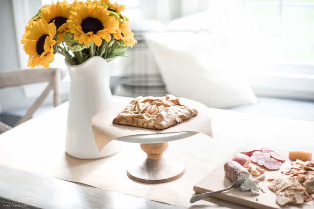 apple crostata and sunflowers in a sunny window