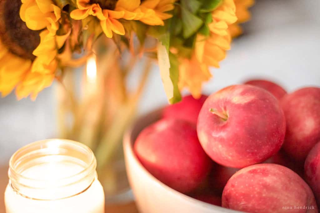 close up of apple bowl and candles